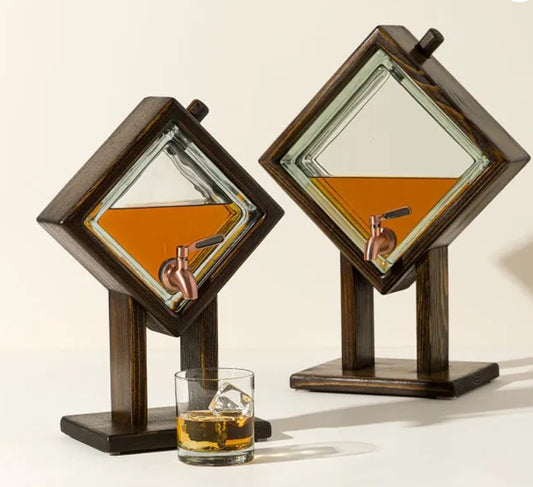 Two wooden cocktail mixers with glass inserts and a glass of whiskey on a white background